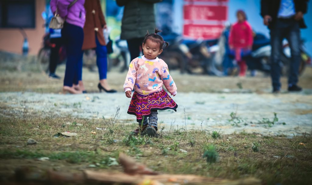 Young Nepali child walking alone through the markets.